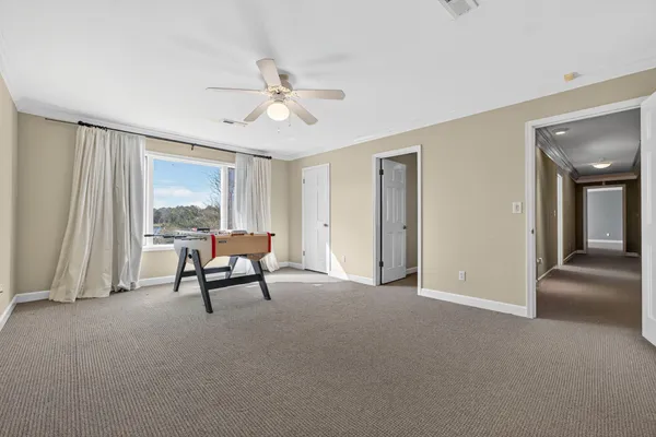 a view of a livingroom with furniture and staircase