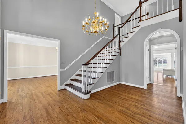 a big room with wooden floor and windows