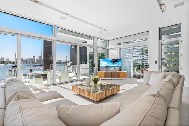 a living room with furniture and a floor to ceiling window