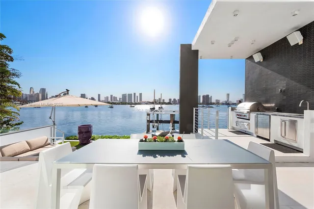 a large white bed sitting in a room next to a window