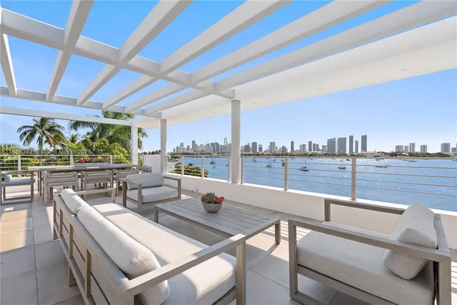 a bedroom with a large bed and a view of kitchen