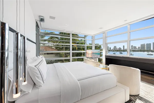 a bedroom with a bed and a table with wooden floor