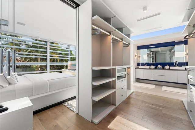 a bedroom with a large bed and a large window