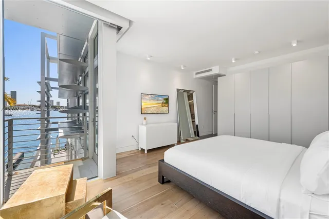 a living room with patio furniture and a floor to ceiling window