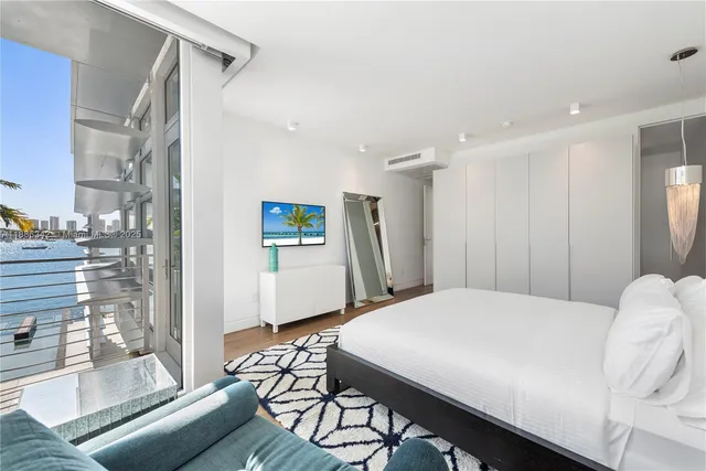 a view of a swimming pool and lounge chairs in the patio