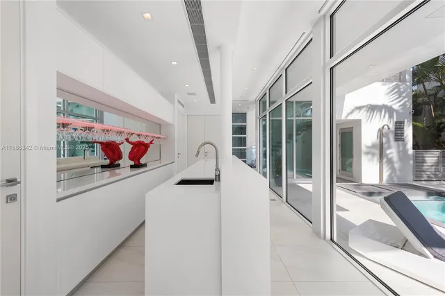 a view of a dining room with furniture large windows and wooden floor