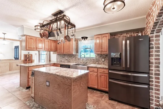 a kitchen with a sink stainless steel appliances and cabinets