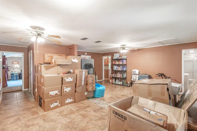 a living room with lots of furniture and chandelier