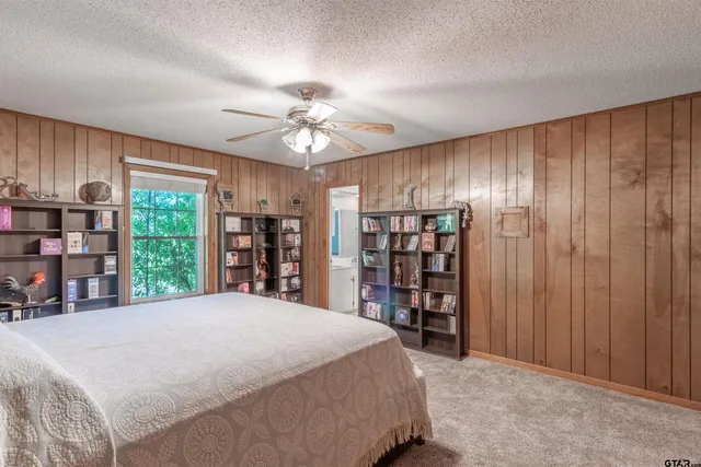 a bed room with a bed and a large window