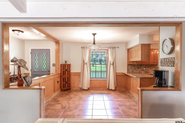a view of a kitchen with fridge and windows