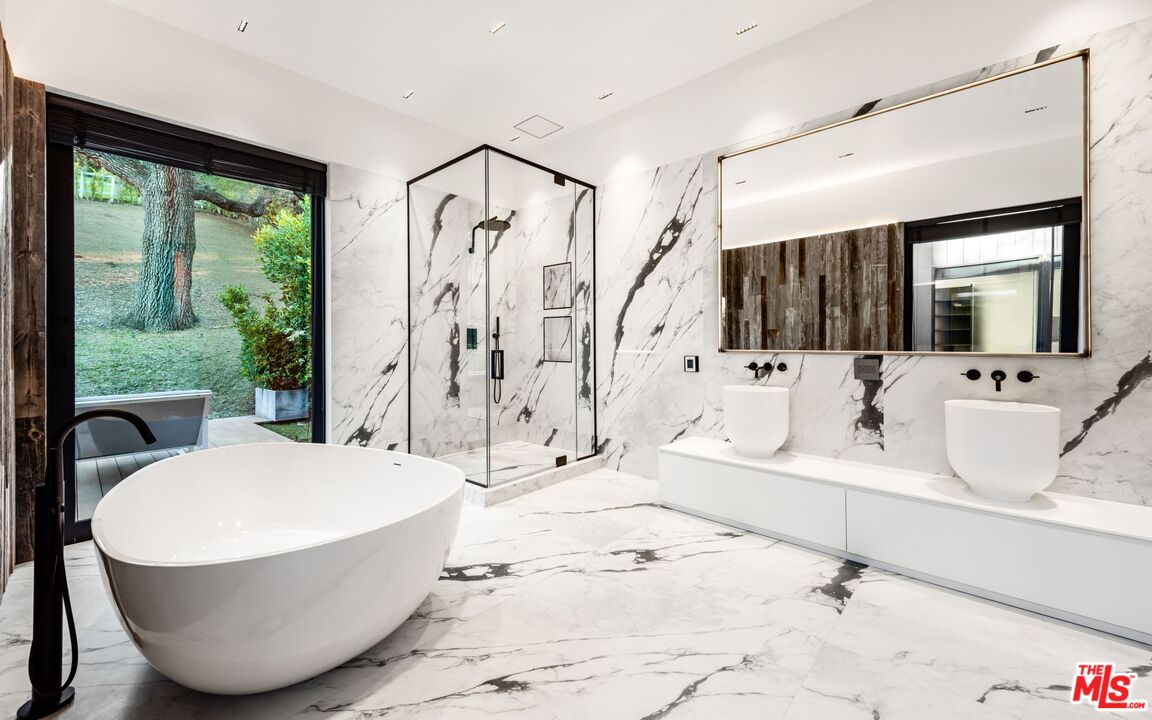24350 Bridle Trail Road Hidden Hills, CA 91302 - Photo 16 of 23 a bathroom with a tub sink and mirror