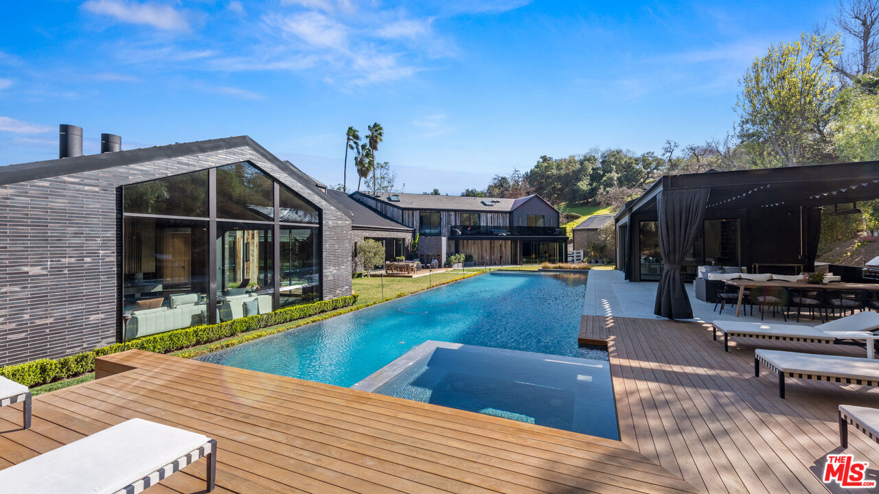 24350 Bridle Trail Road Hidden Hills, CA 91302 - Photo 2 of 23 a view of a house with swimming pool and sitting area