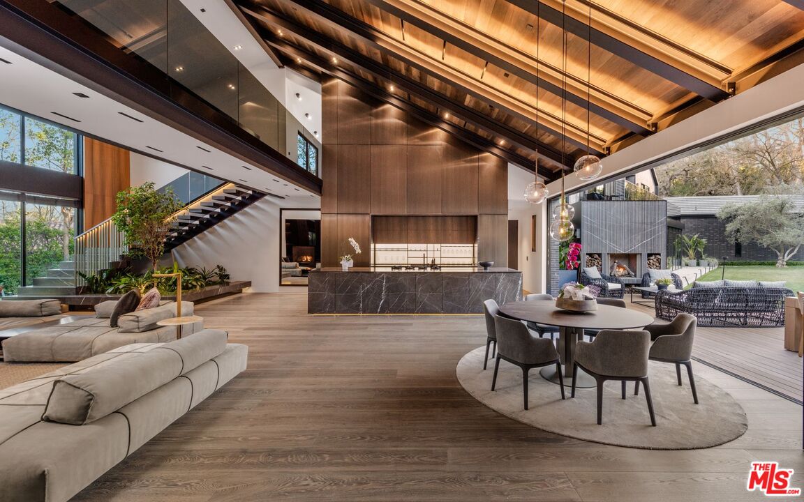 24350 Bridle Trail Road Hidden Hills, CA 91302 - Photo 6 of 23 a view of a patio with table and chairs potted plants with wooden floor and seating space