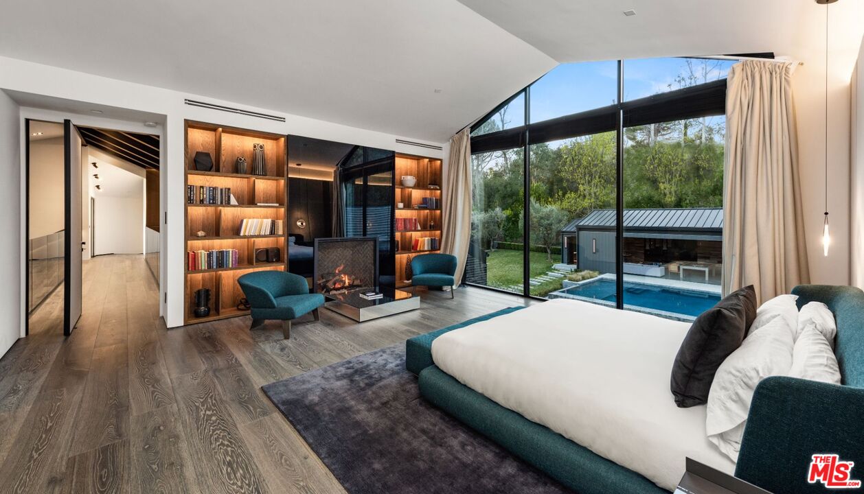 24350 Bridle Trail Road Hidden Hills, CA 91302 - Photo 8 of 23 a bedroom with a bed and wooden floor