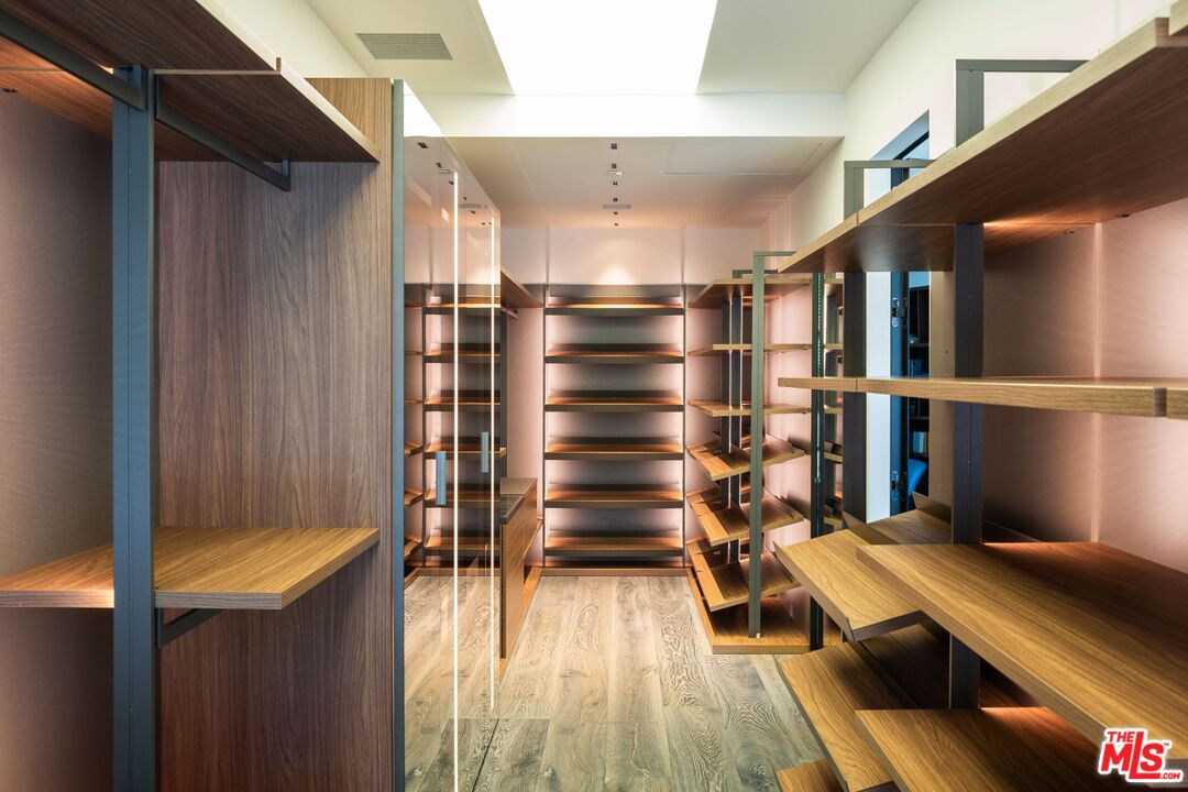 24350 Bridle Trail Road Hidden Hills, CA 91302 - Photo 9 of 23 a view of walk in closet with clothes and shoes