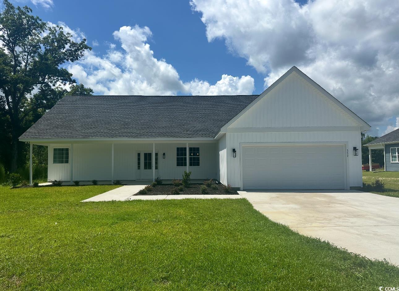 Ranch-style home featuring roof with shingles, a g
