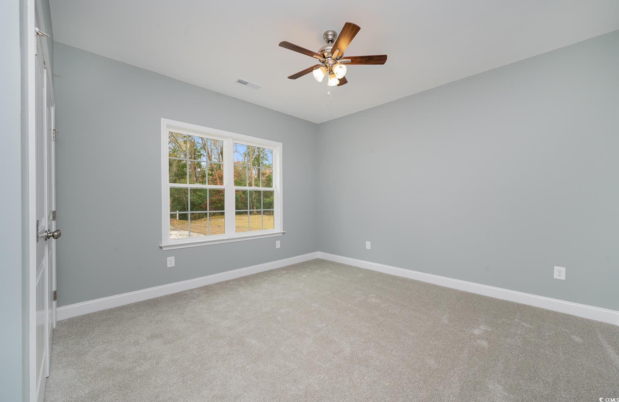 357 Log Cabin Road Loris, SC 29569 - Photo 9 of 27 Spare room with light colored carpet and ceiling f