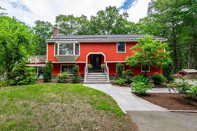 a front view of a house with a garden