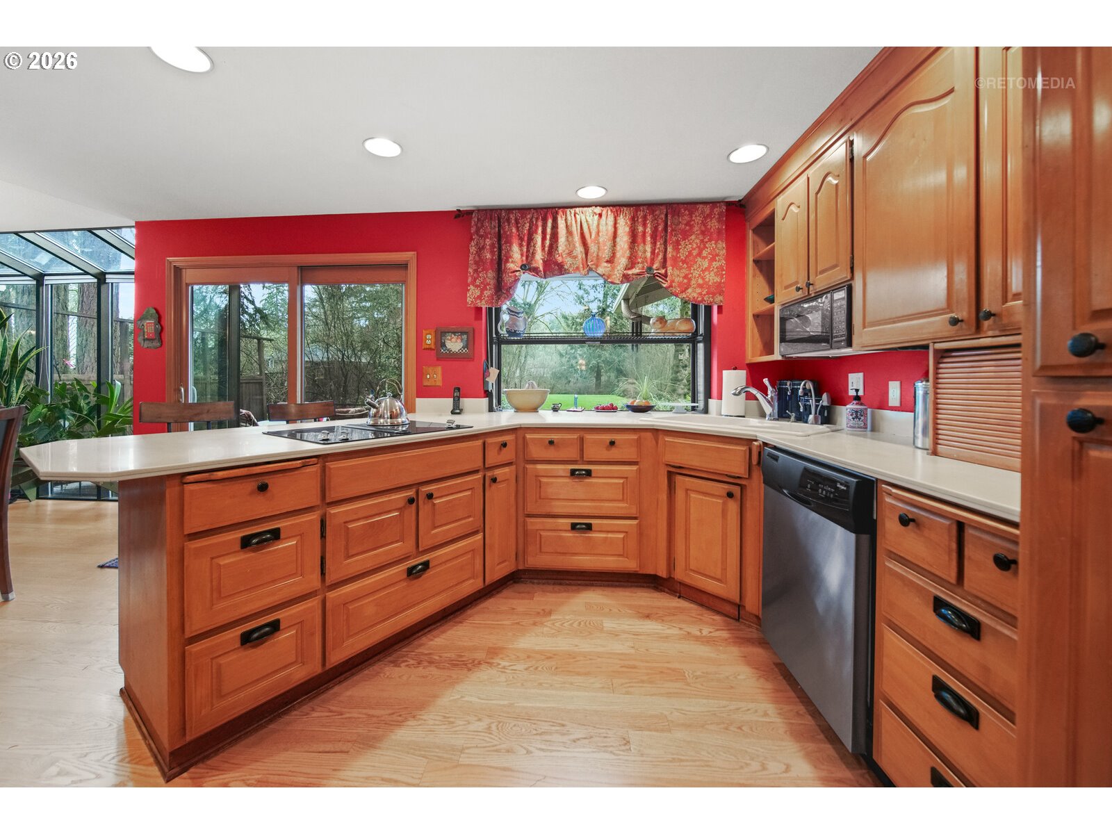 17738 Kelok Road Lake Oswego, OR 97034 - Photo 9 of 48 a kitchen with stainless steel appliances kitchen island granite countertop a stove a sink and a microwave