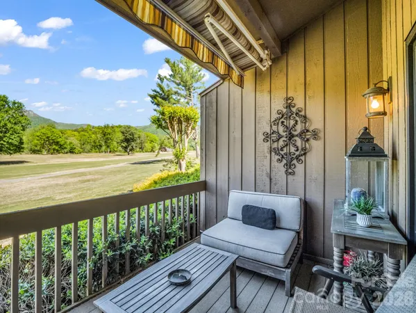 a view of a balcony with chair and table
