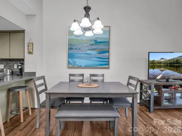 a view of a dining room with furniture and wooden floor