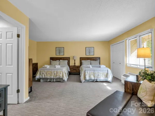 a bedroom with bed and window
