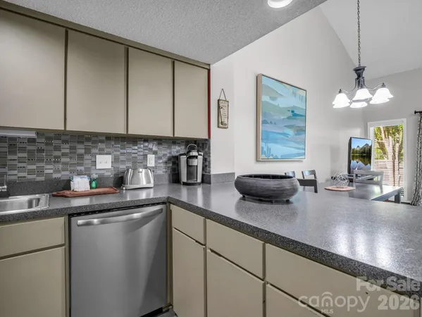 a kitchen with sink a window and cabinets