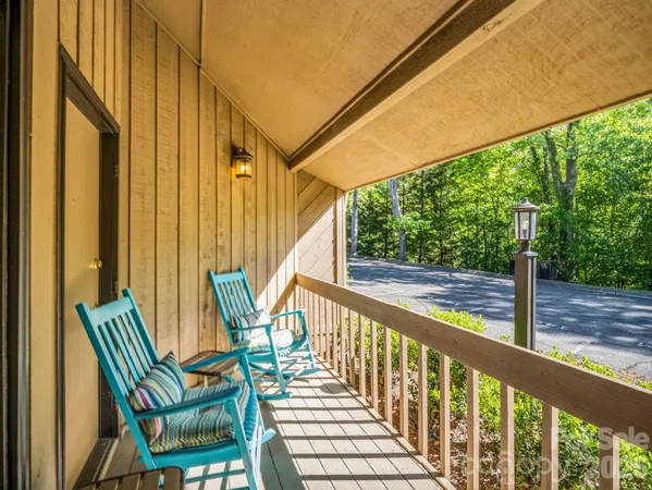 a view of a chairs and table in the balcony