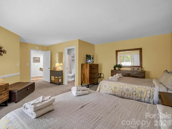 a bedroom with a bed couch and a view living room