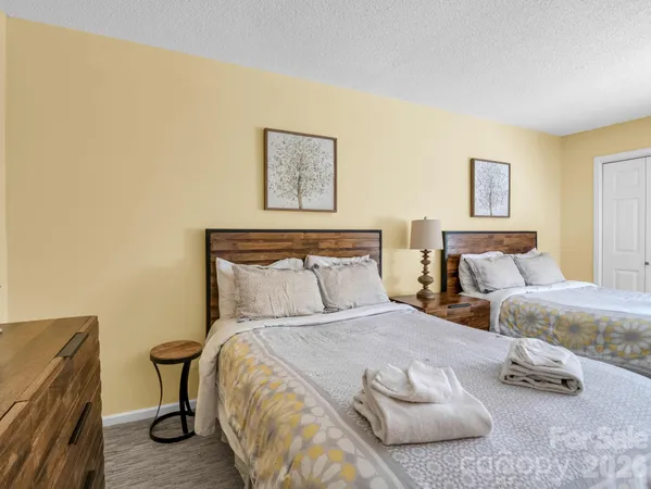 a bedroom with bed and night stand