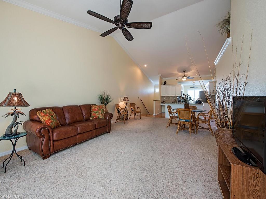 1095 Partridge Circle, Unit 201 Naples, FL 34104 - Photo 2 of 12 a living room with furniture and a flat screen tv