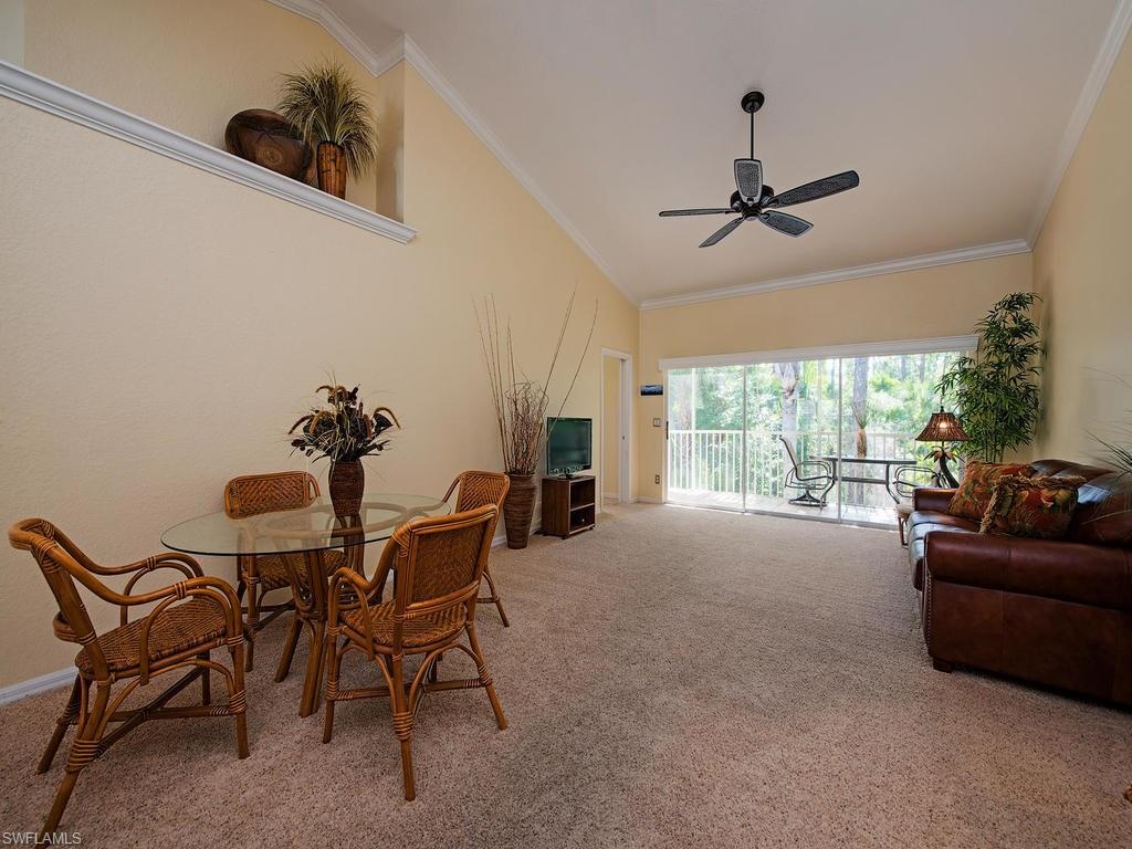1095 Partridge Circle, Unit 201 Naples, FL 34104 - Photo 4 of 12 a living room with furniture and a fireplace