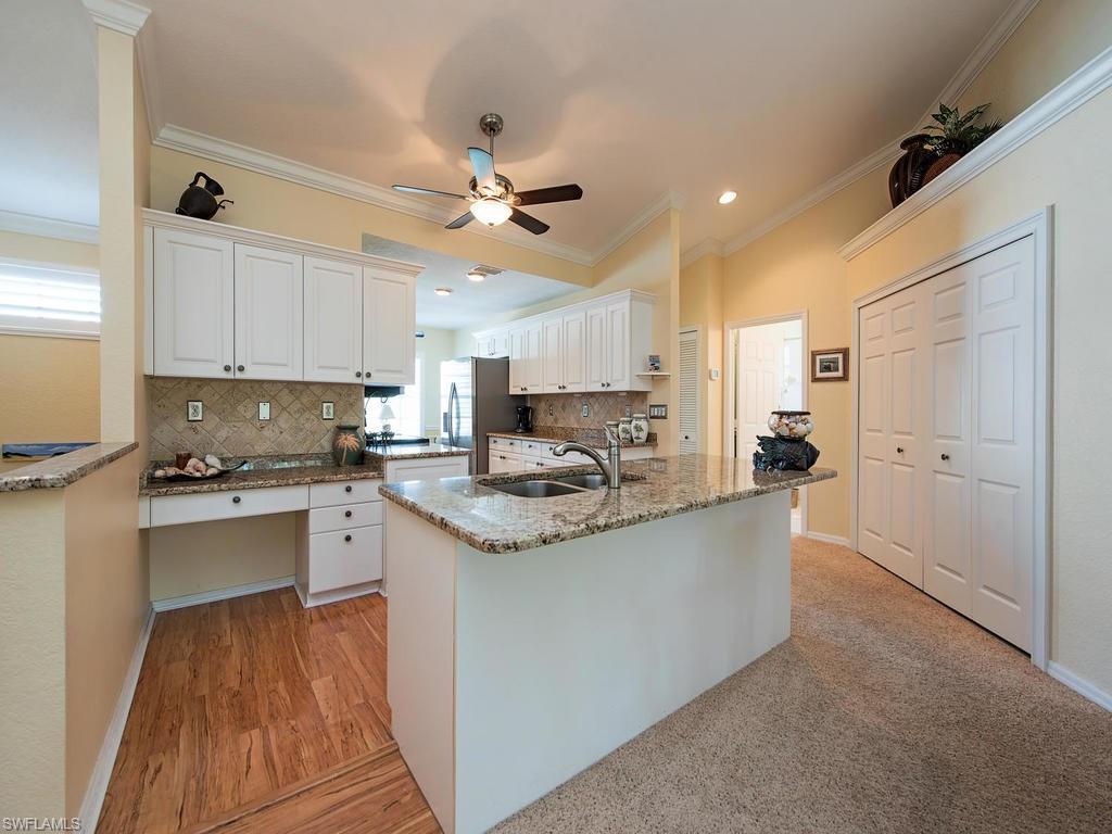 1095 Partridge Circle, Unit 201 Naples, FL 34104 - Photo 6 of 12 a kitchen with granite countertop a sink stove and refrigerator