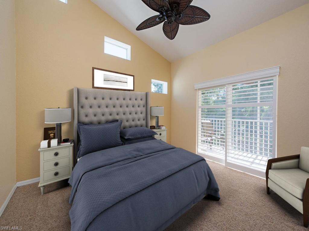 1095 Partridge Circle, Unit 201 Naples, FL 34104 - Photo 7 of 12 a bedroom with a bed a couch and a chandelier