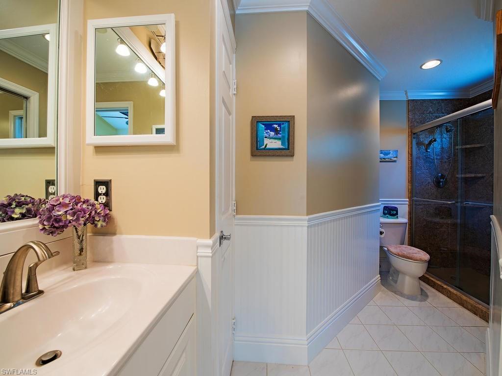 1095 Partridge Circle, Unit 201 Naples, FL 34104 - Photo 8 of 12 a bathroom with a sink toilet and shower