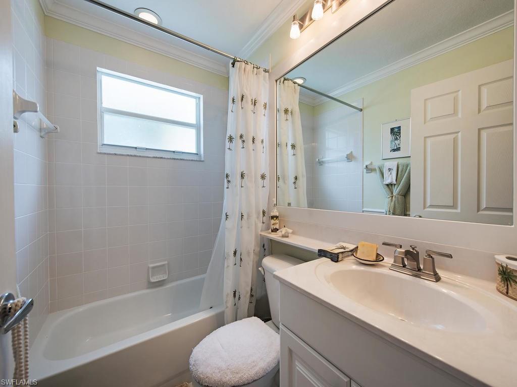 1095 Partridge Circle, Unit 201 Naples, FL 34104 - Photo 10 of 12 a bathroom with a sink toilet tub and shower