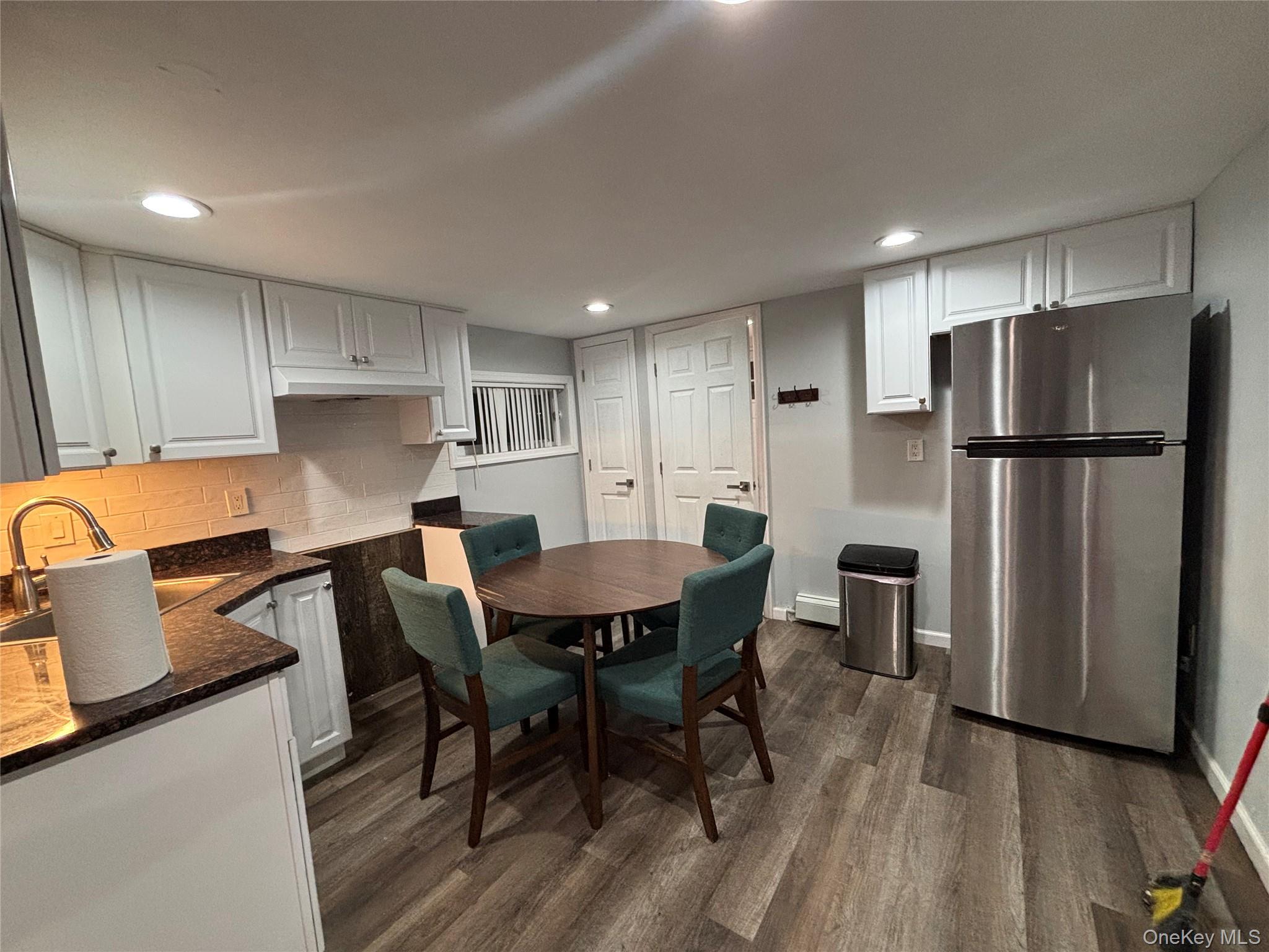 832 Jefferson Street Baldwin, NY 11510 - Photo 5 of 5 a kitchen with a refrigerator a table and chairs