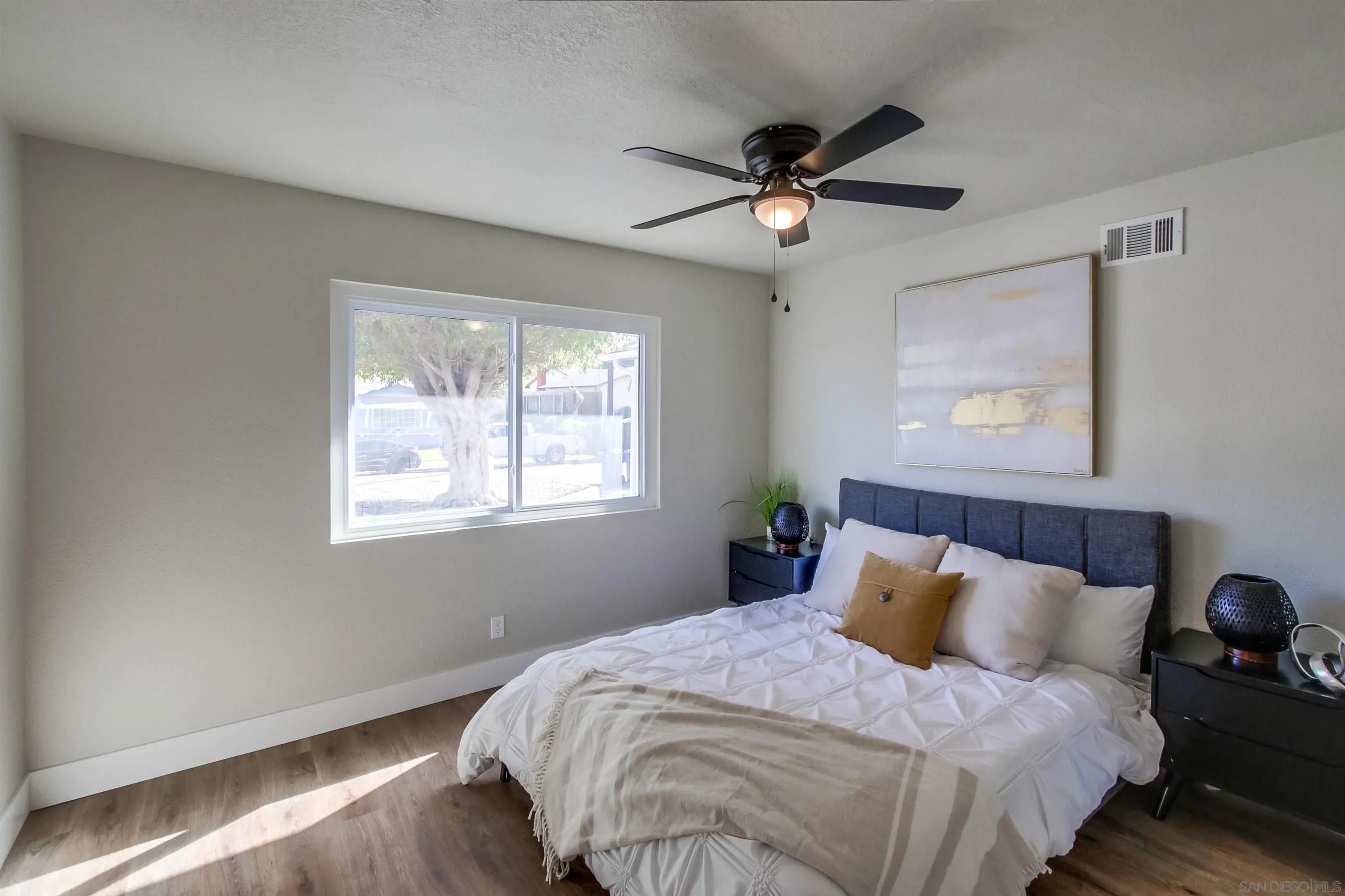 238 69th Street San Diego, CA 92114 - Photo 12 of 27 a bedroom with a large bed and a window