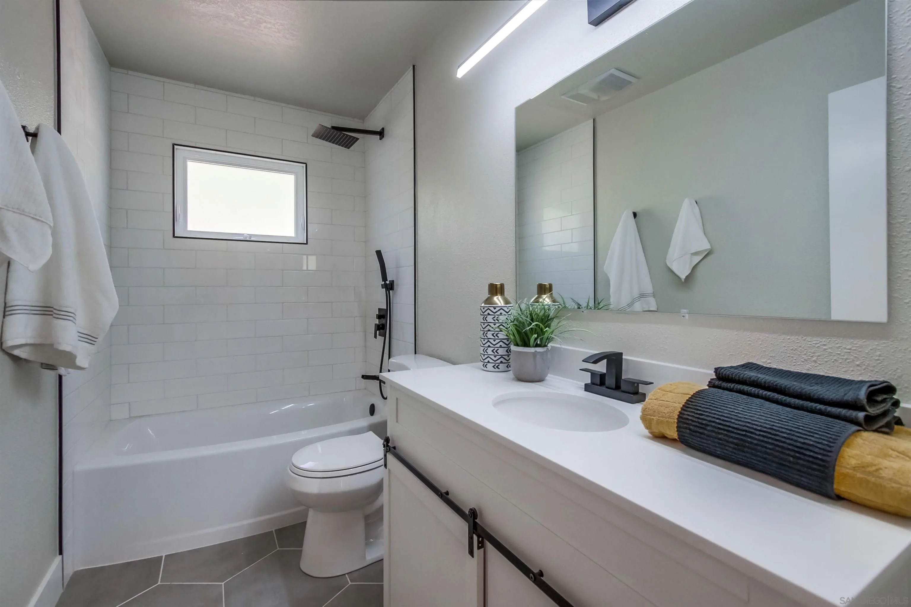 238 69th Street San Diego, CA 92114 - Photo 14 of 27 a bathroom with a sink a toilet and shower