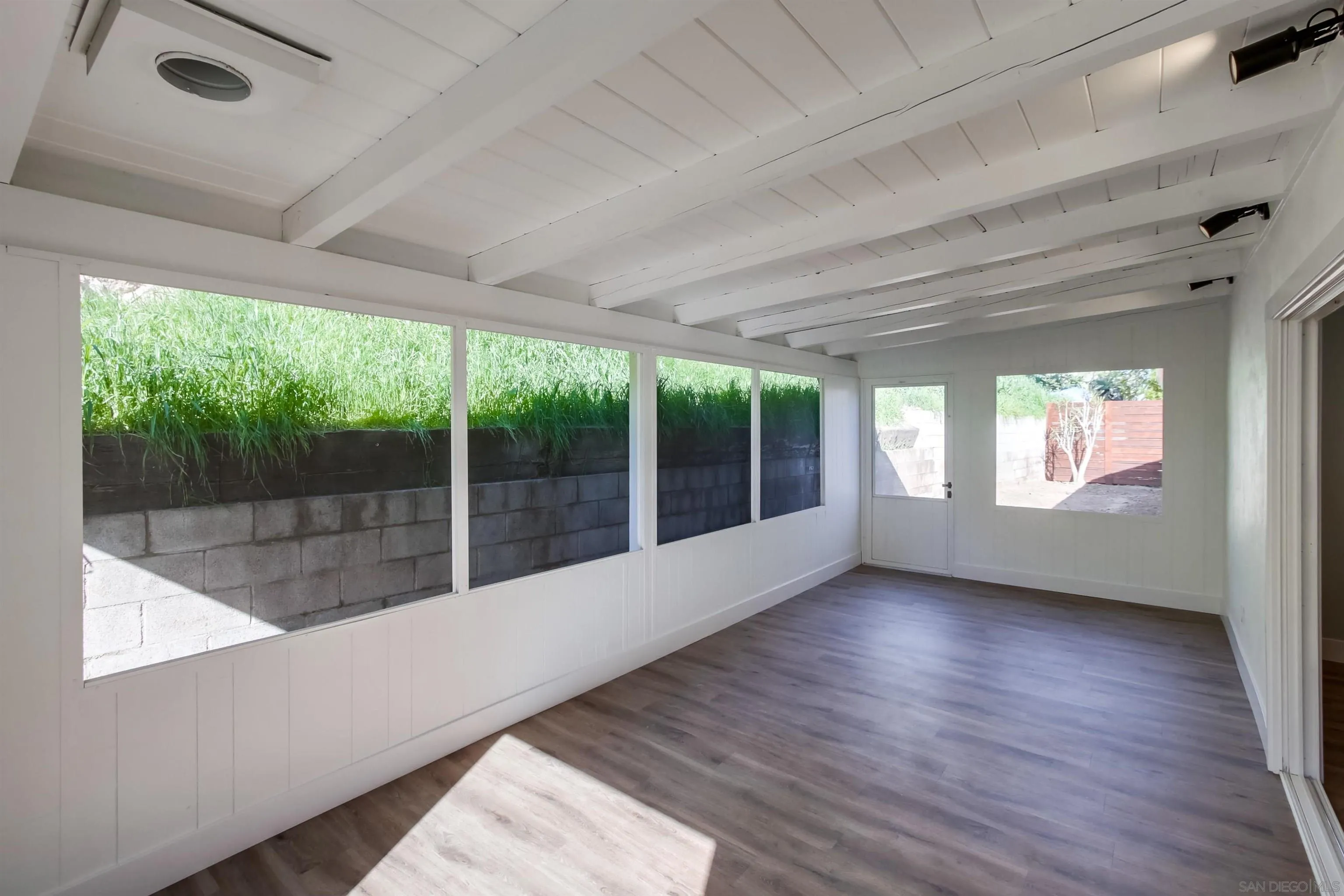 238 69th Street San Diego, CA 92114 - Photo 17 of 27 a view of outdoor space with wooden floor and windows