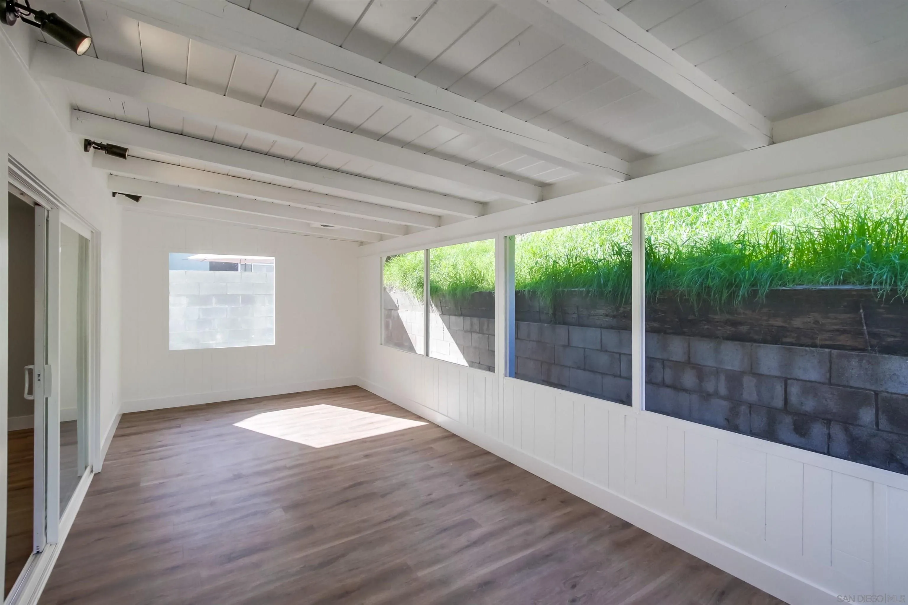 238 69th Street San Diego, CA 92114 - Photo 18 of 27 a view of empty room with wooden floor and fan