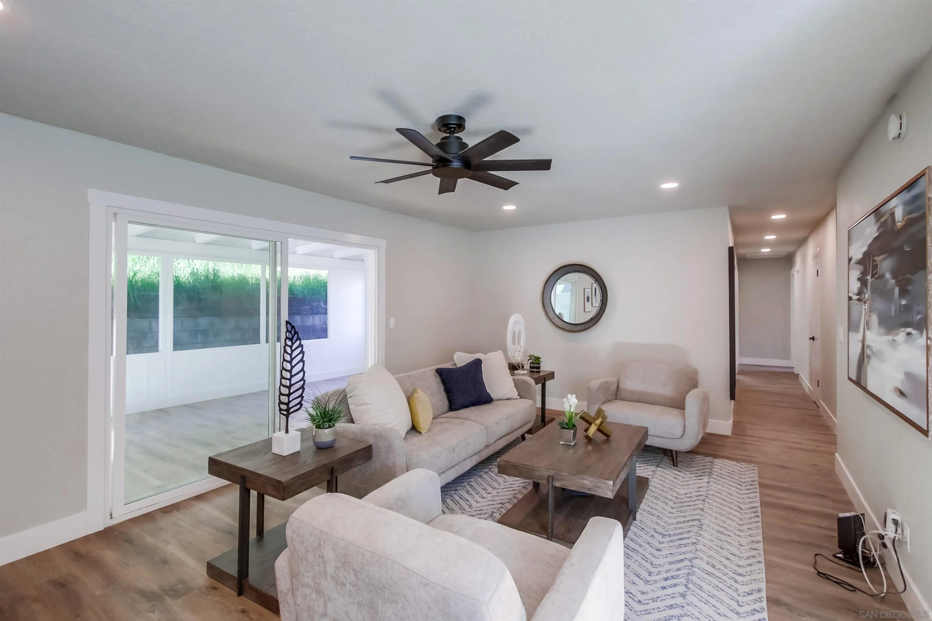 238 69th Street San Diego, CA 92114 - Photo 4 of 27 a living room with furniture a window and a chandelier