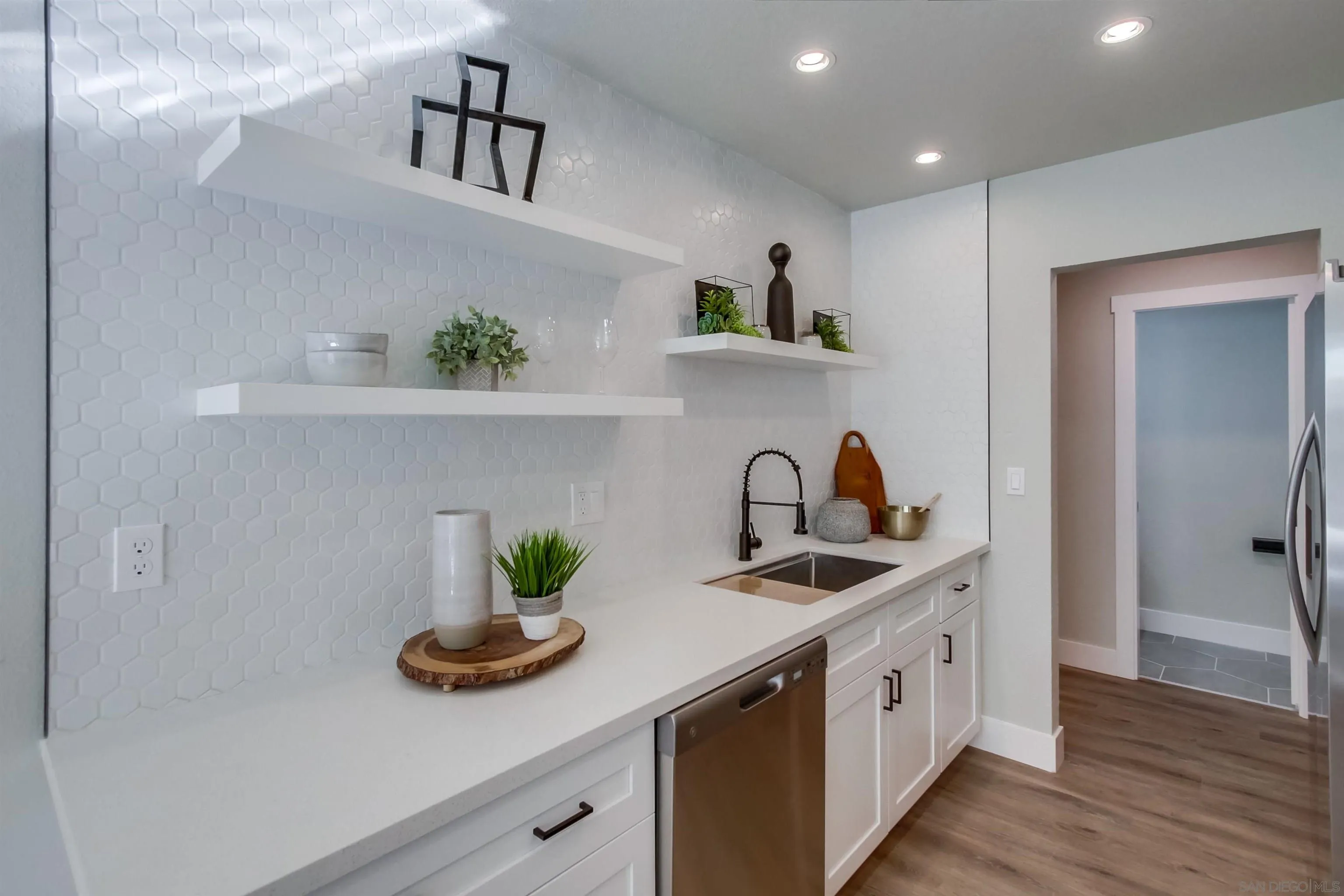 238 69th Street San Diego, CA 92114 - Photo 7 of 27 a kitchen with stainless steel appliances a sink and cabinets