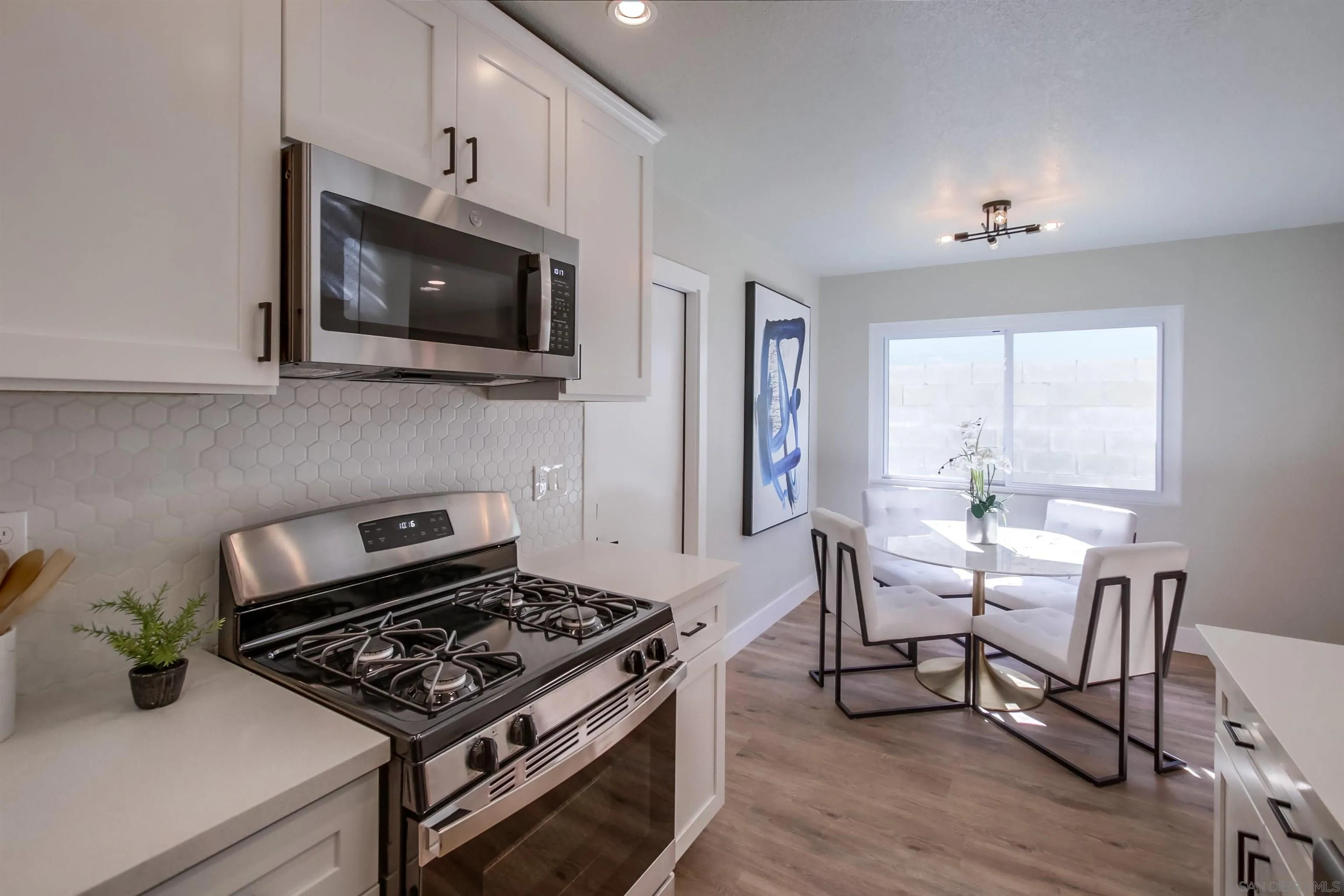 238 69th Street San Diego, CA 92114 - Photo 8 of 27 a kitchen with a stove and a microwave