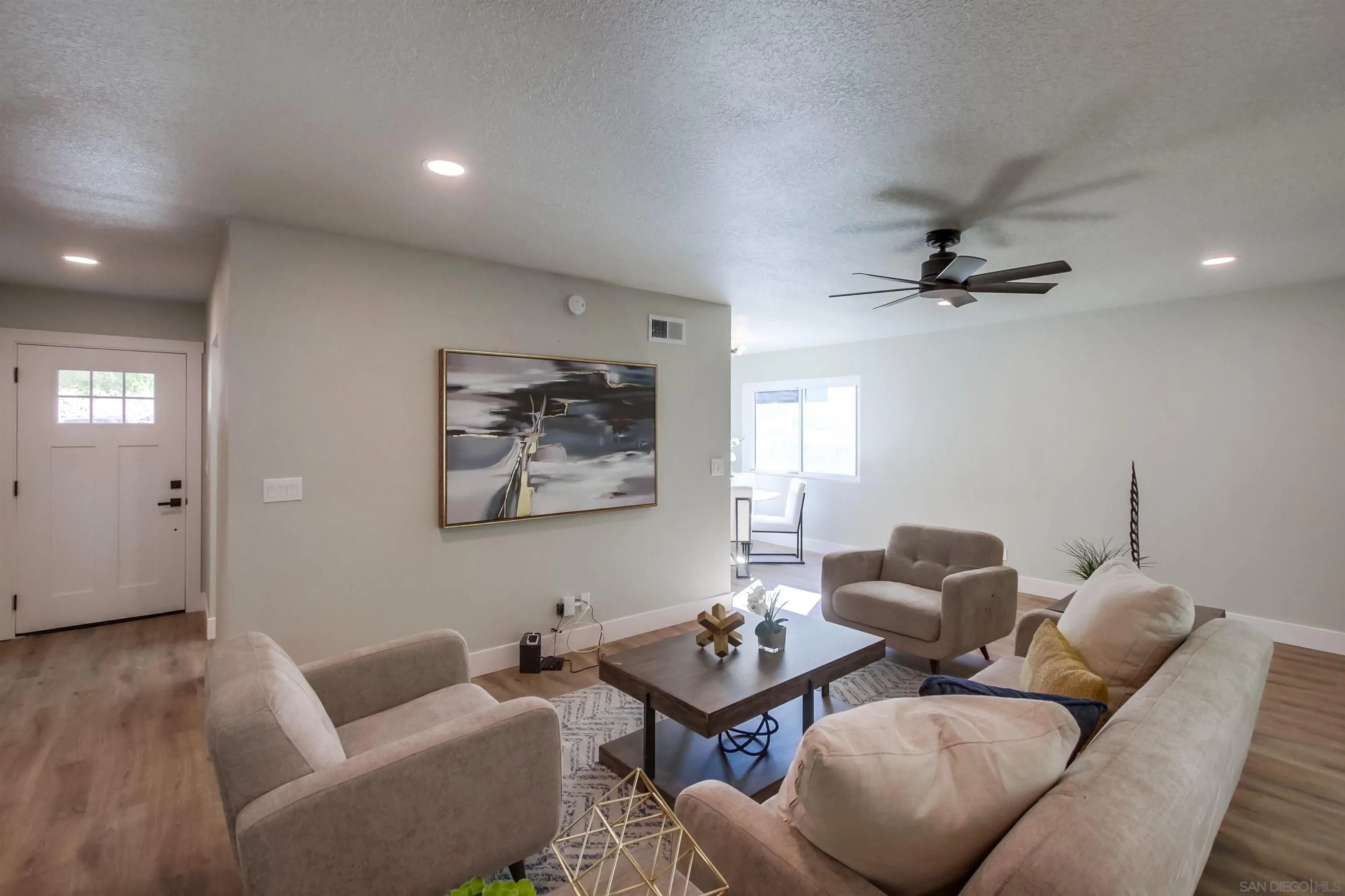 238 69th Street San Diego, CA 92114 - Photo 10 of 27 a living room with furniture and a wooden floor