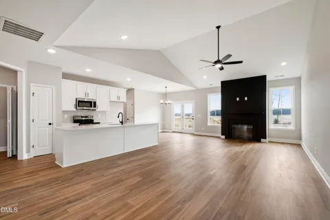 a view of kitchen with sink and refrigerator