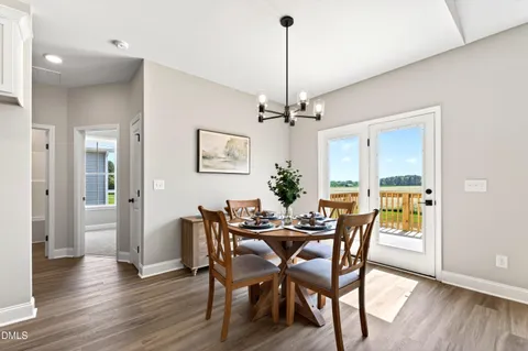 a view of a dining room with furniture wooden floor and chandelier
