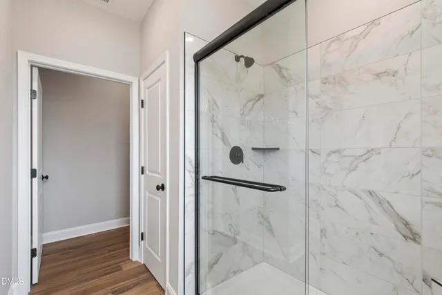 a bathroom with a glass shower door