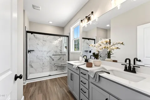 a bathroom with a glass shower door