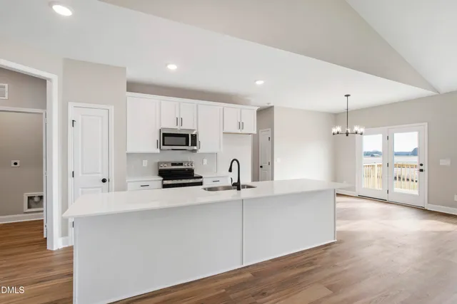 a kitchen with stainless steel appliances a refrigerator sink and microwave